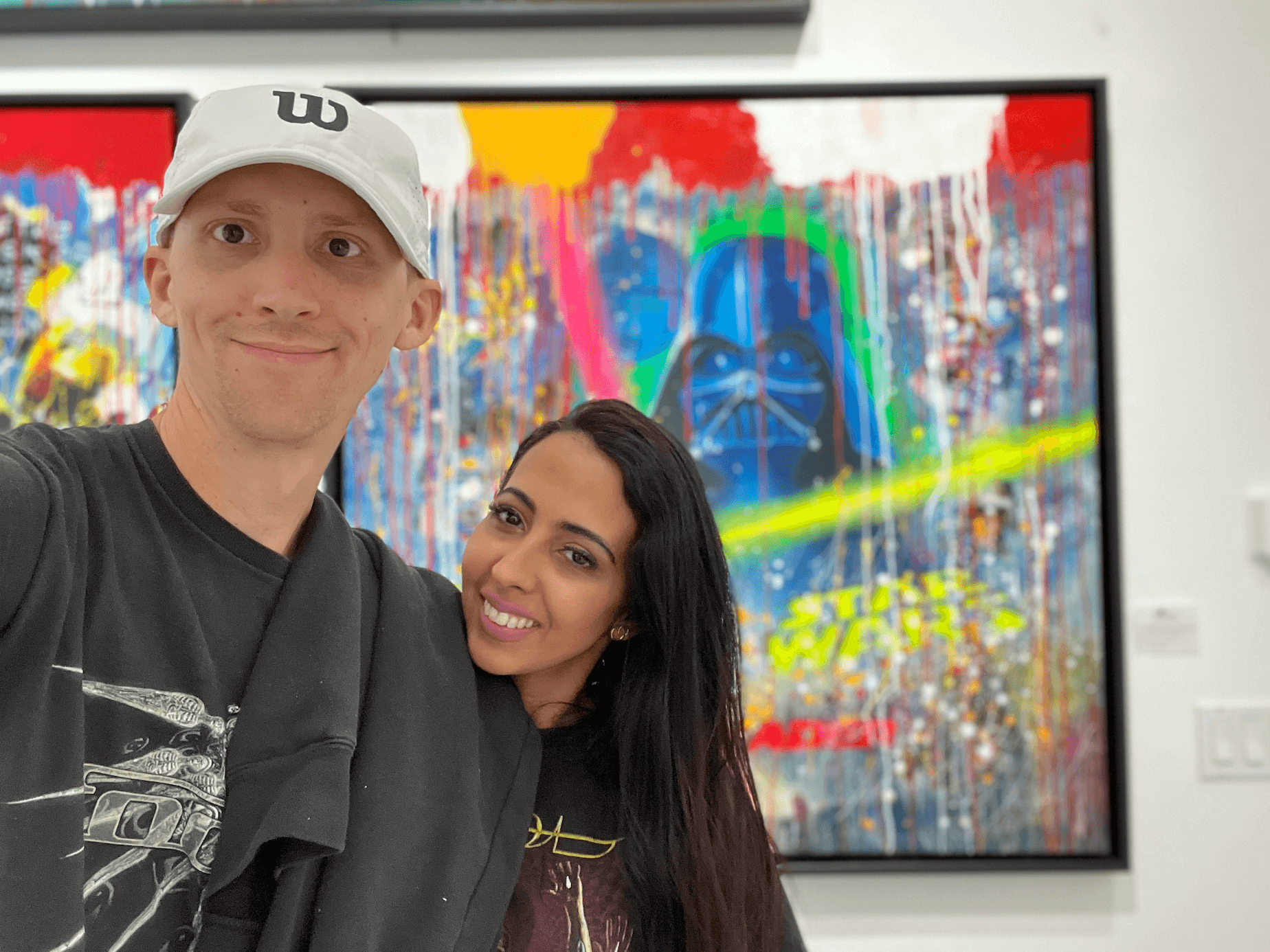 Ethan Lazuk and Dania Lazuk in an art gallery.